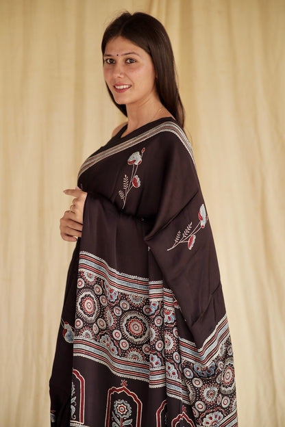Premium charcoal black modal silk saree with heritage-inspired Ajrakh designs and fluid fall