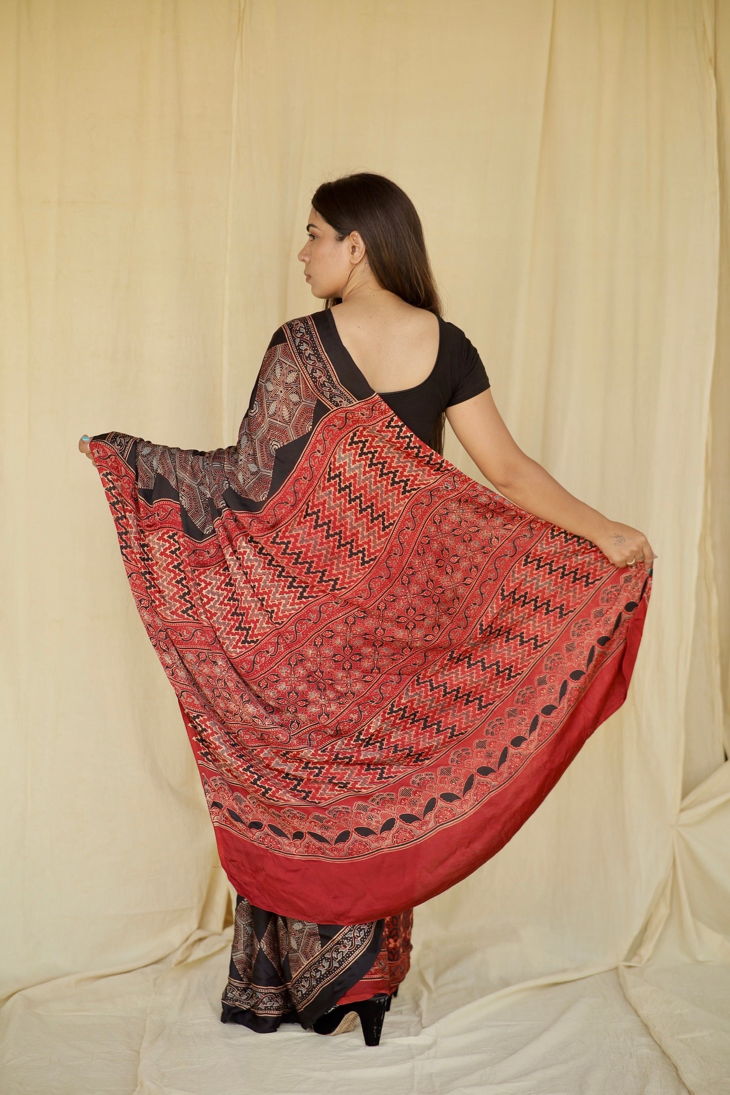 Premium dark mocha modal silk saree with heritage-inspired Ajrakh designs and fluid texture