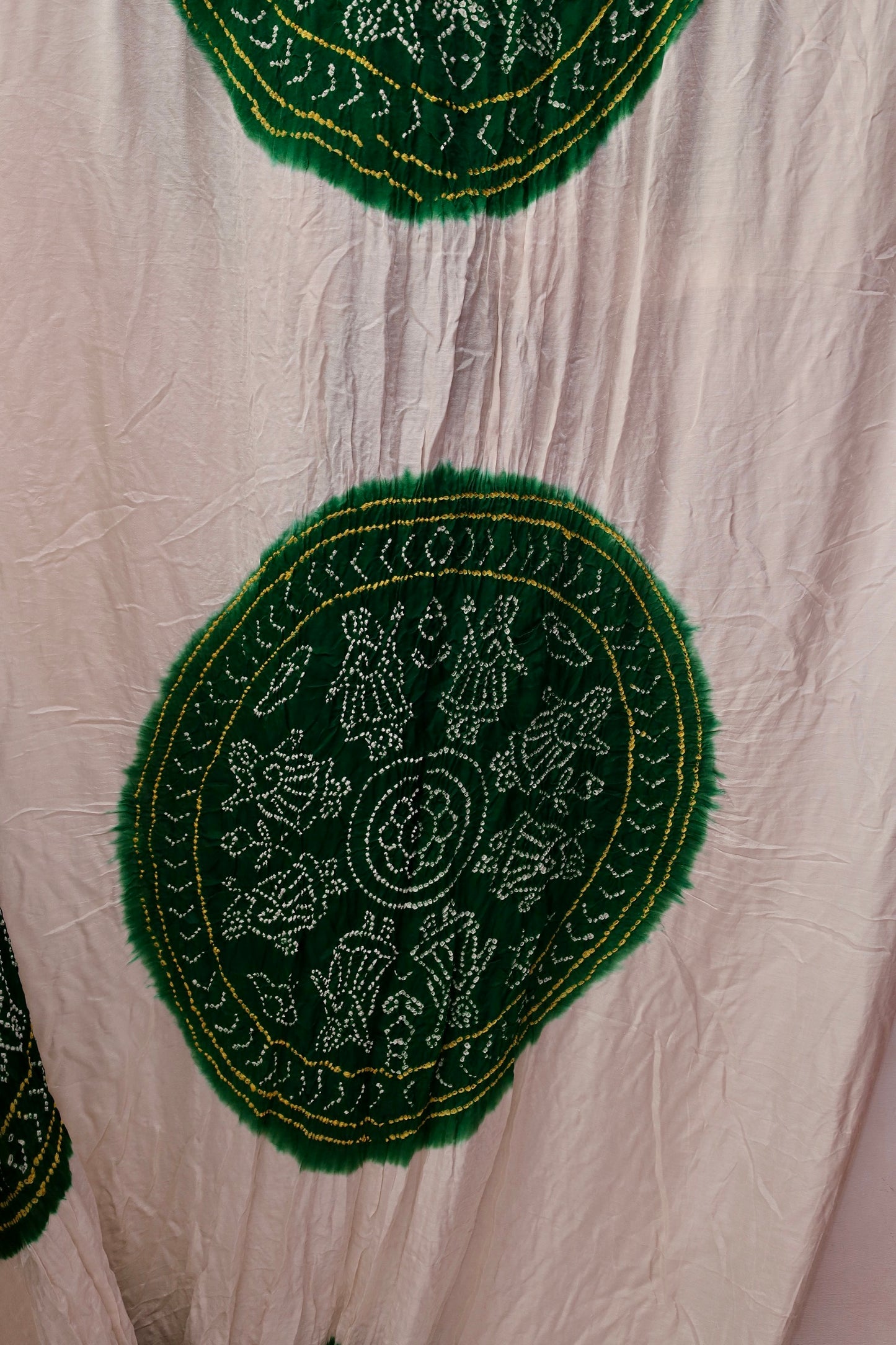 Handcrafted emerald Gajji silk saree showcasing authentic Bandhani artistry with rich zari detailing