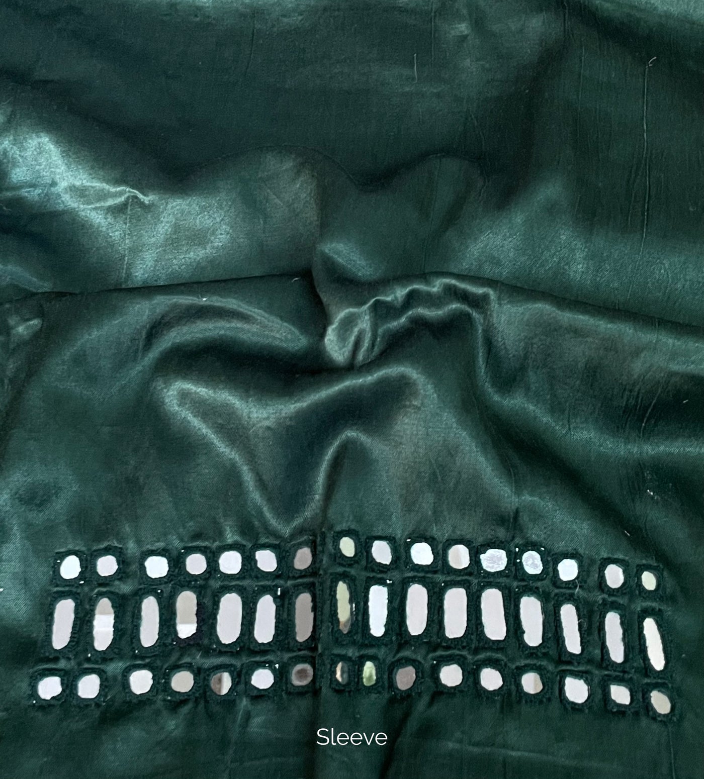 Forest green mirror work blouse piece showcasing intricate handcrafted embellishments