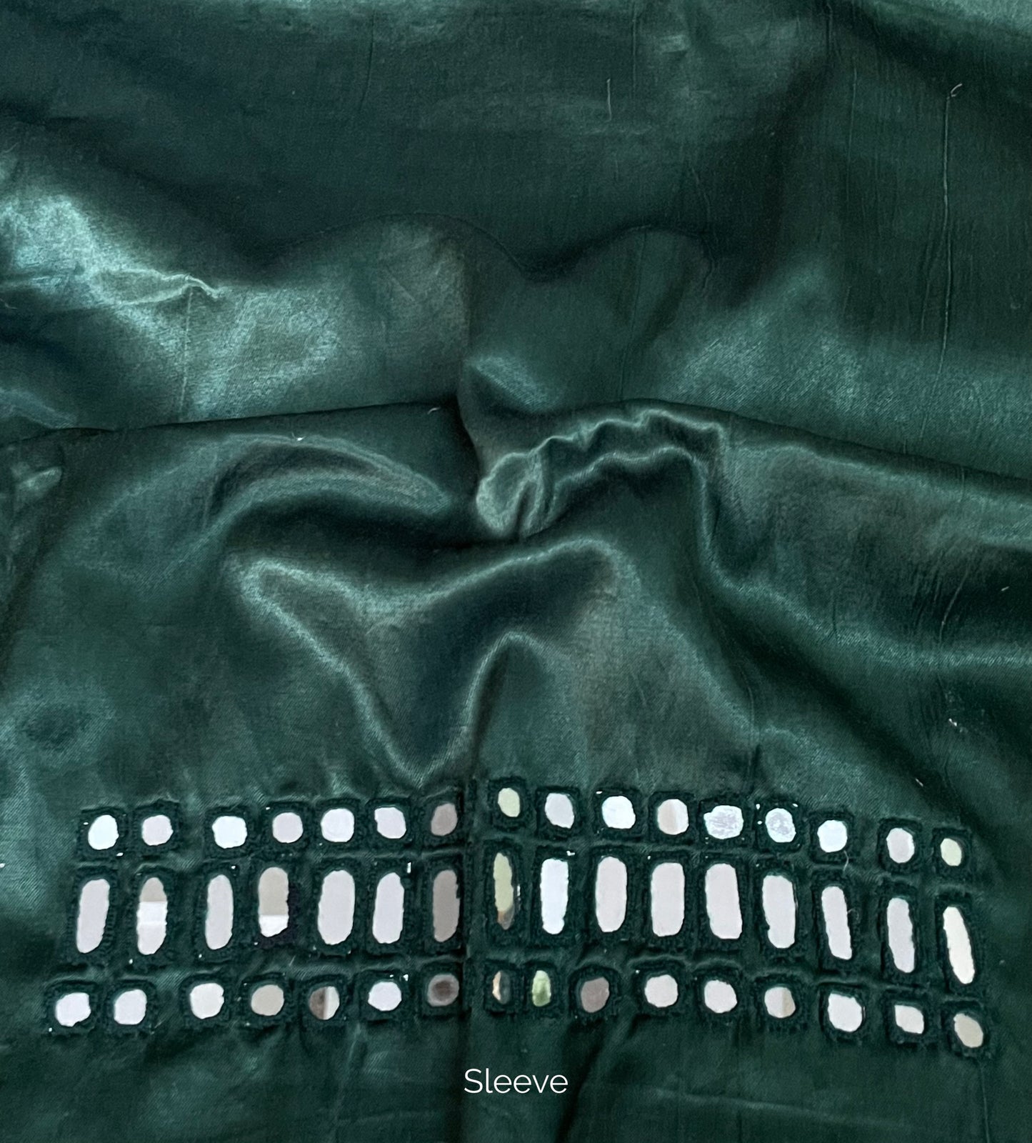Forest green mirror work blouse piece showcasing intricate handcrafted embellishments