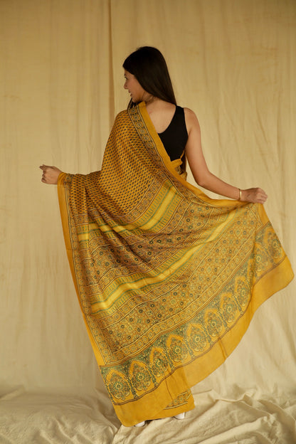 Premium golden mustard Chanderi silk saree with heritage-inspired Ajrakh designs and subtle sheen
