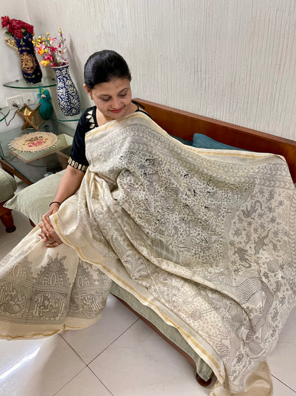 Handcrafted ivory white Mata Ni Pachedi saree adorned with authentic handpainted designs inspired by Gujarat's folk art heritage