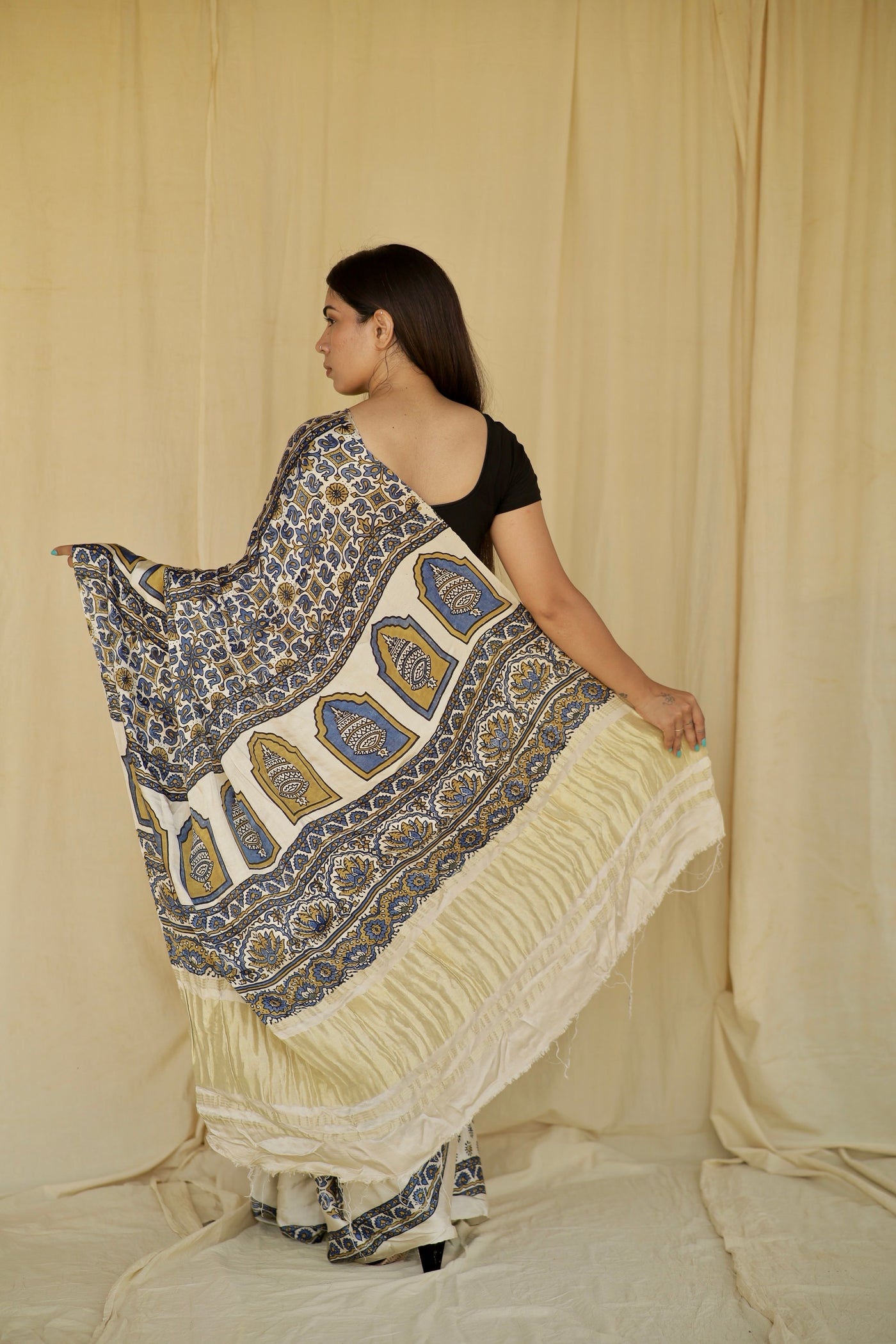 Ivory white modal silk saree with heritage-inspired Ajrakh designs and a soft flowing texture