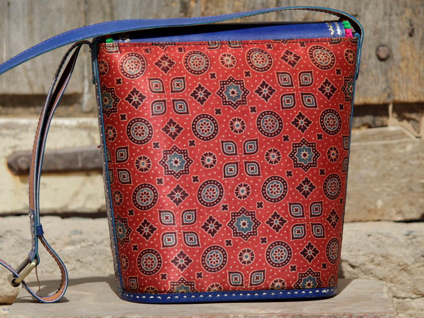 Handcrafted leather bag adorned with traditional Kutchi embroidered motifs and metallic zari detailing