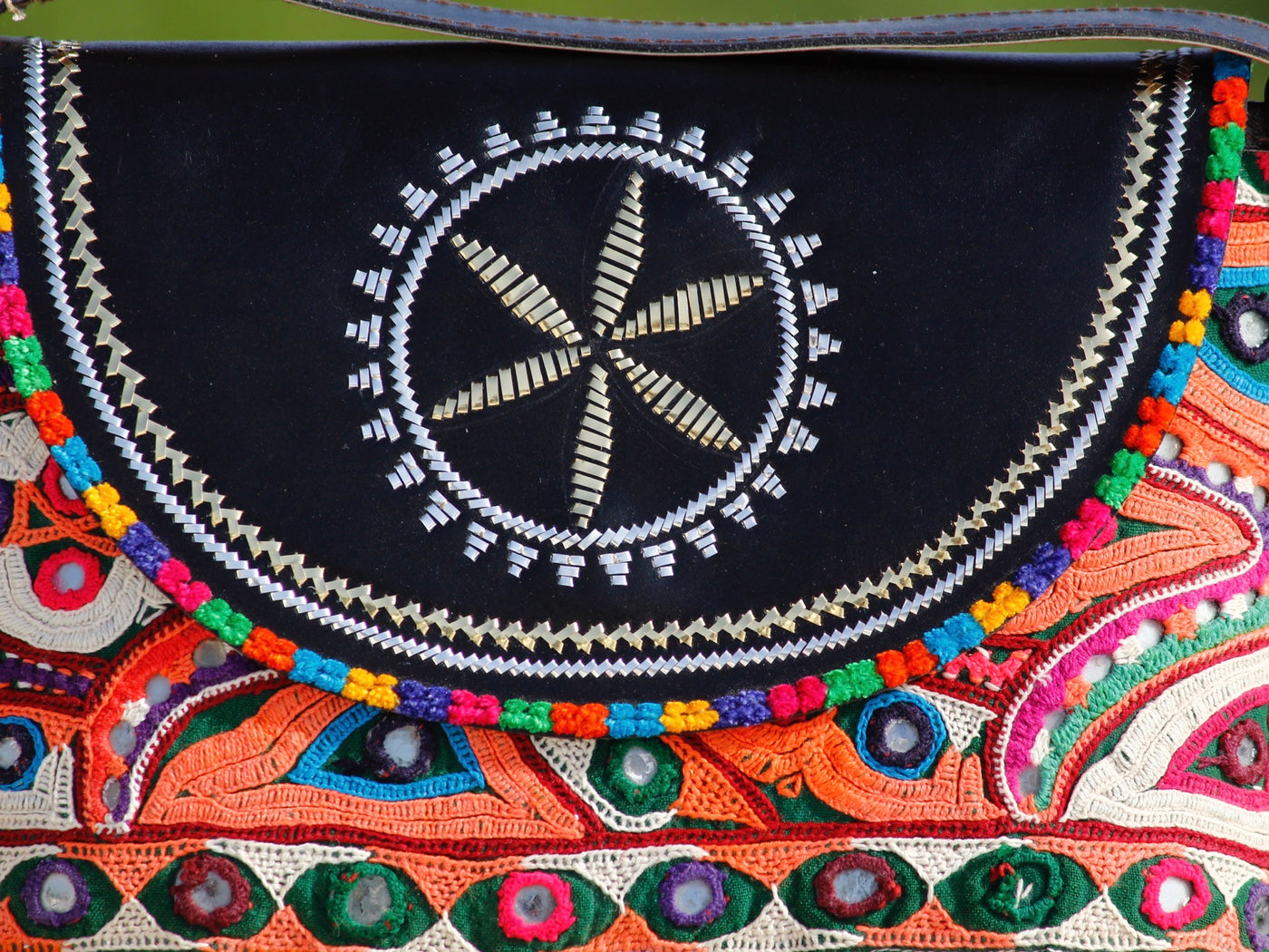 Handcrafted leather bag featuring traditional Kutchi embroidered motifs and fine detailing
