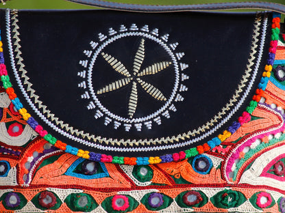 Handcrafted leather bag featuring traditional Kutchi embroidered motifs and fine detailing