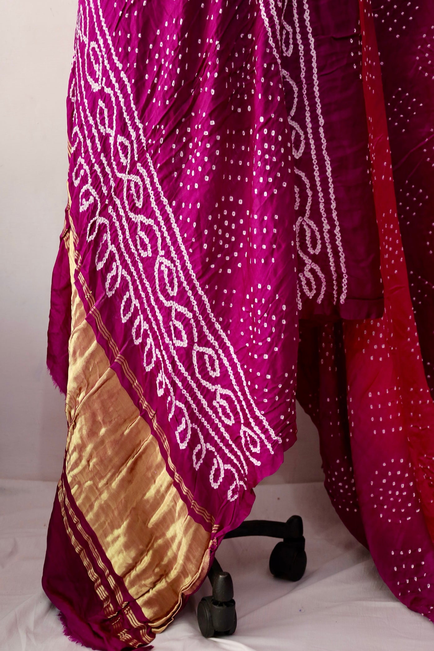 Handcrafted magenta Gajji silk saree showcasing authentic Bandhani artistry with rich zari detailing