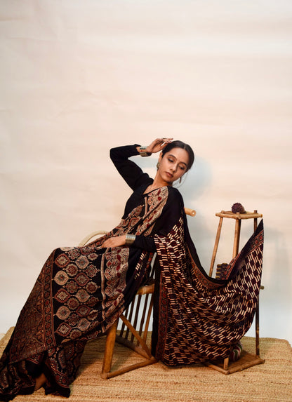Elegant midnight black modal silk saree with heritage-inspired Ajrakh designs and fluid fall