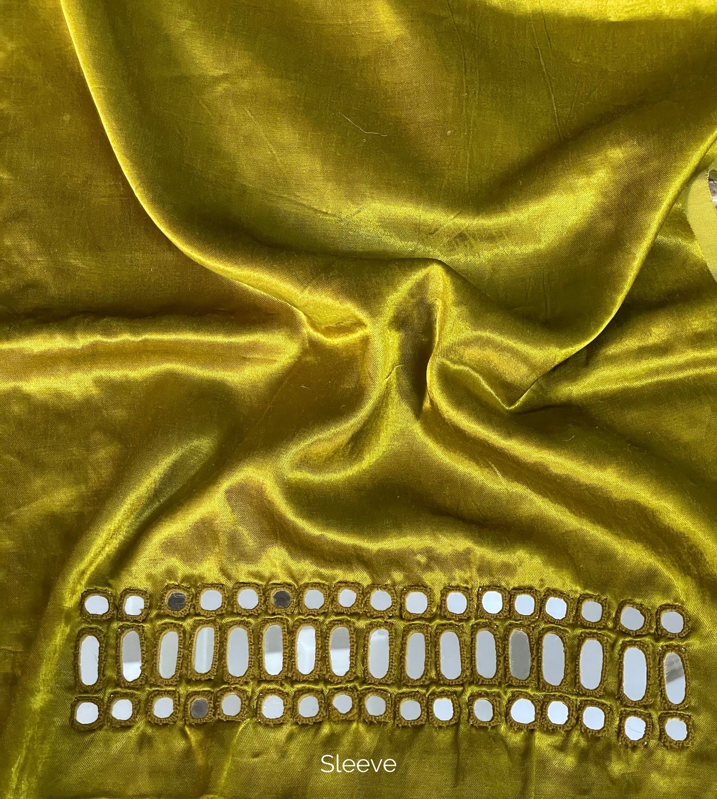 Olive gold mirror work blouse piece showcasing intricate handcrafted embellishments