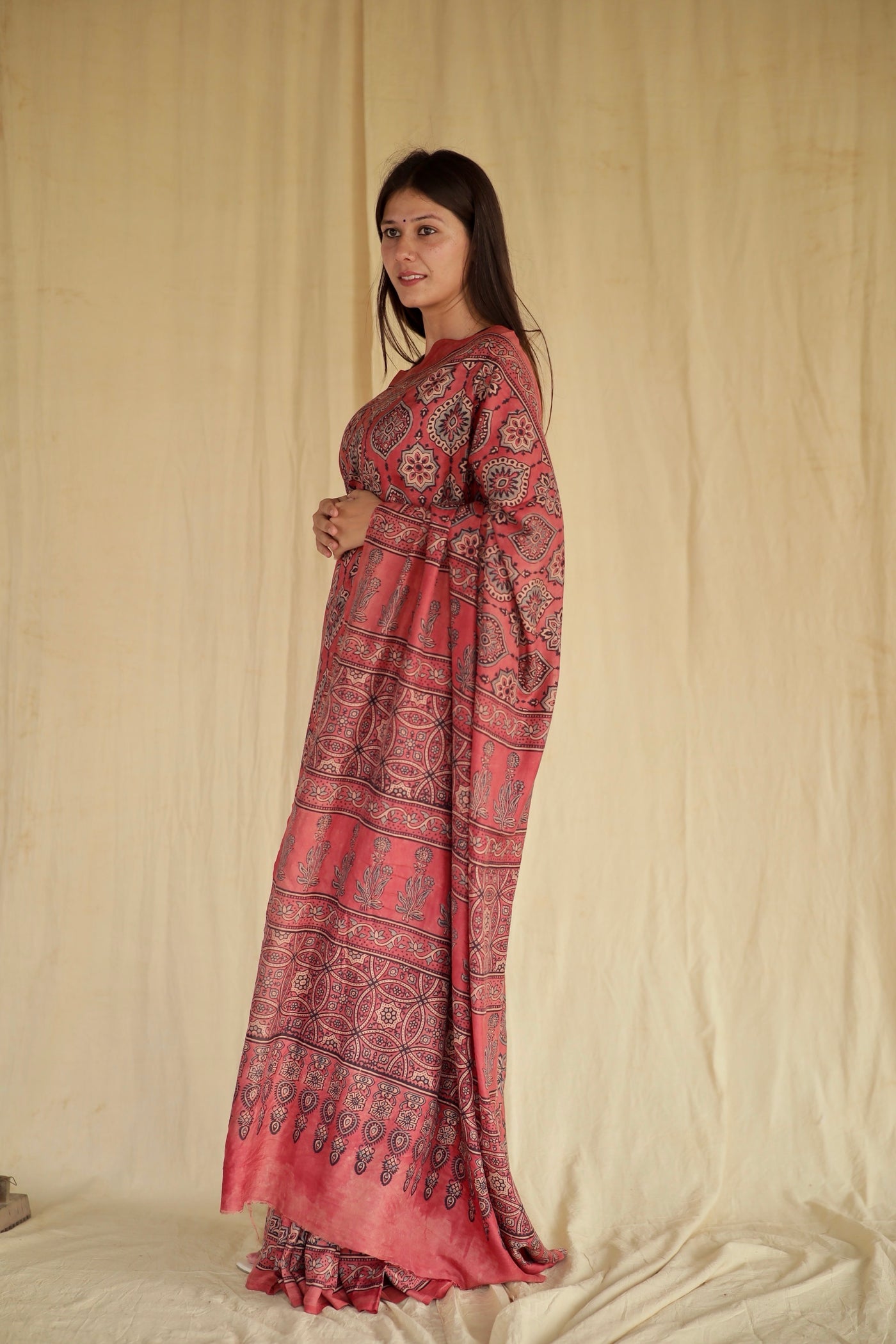 Handcafted raspberry pink Chanderi silk saree adorned with traditional Ajrakh patterns and delicate texture