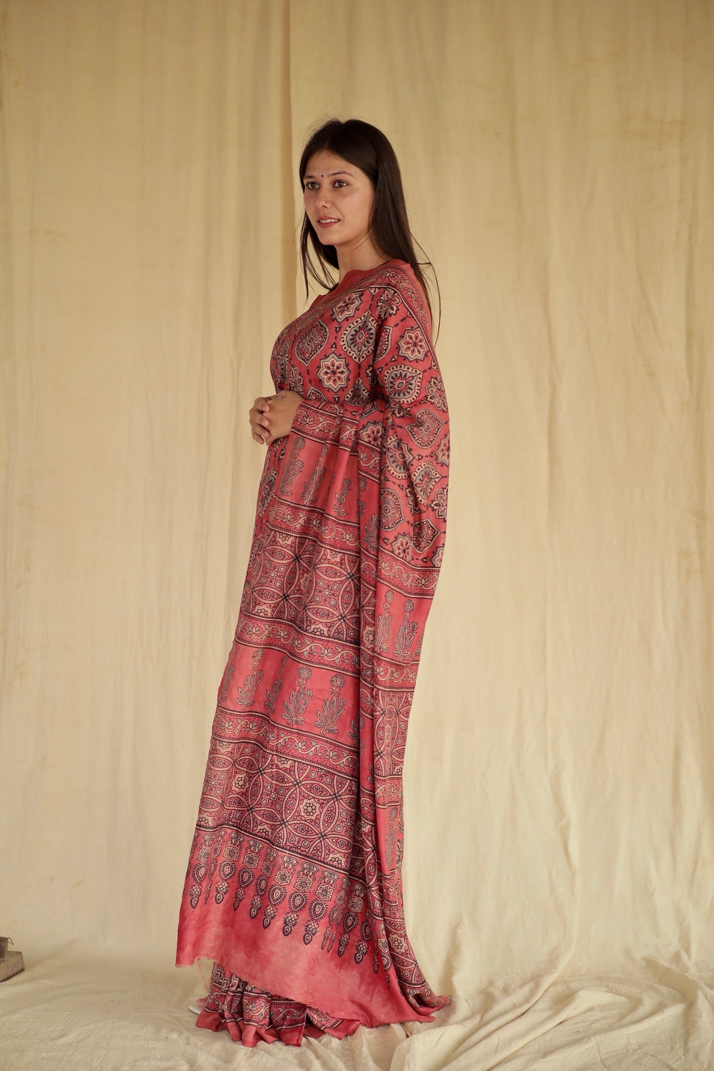 Handcafted raspberry pink Chanderi silk saree adorned with traditional Ajrakh patterns and delicate texture
