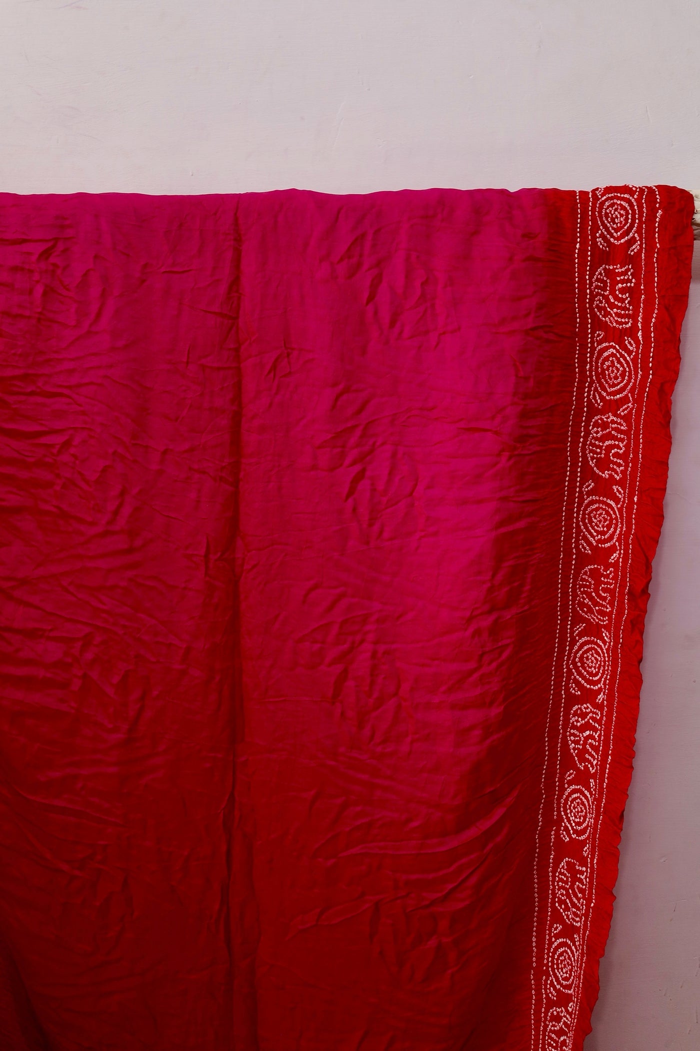 Handcrafted ruby Gajji silk saree showcasing authentic Bandhani artistry with rich zari detailing