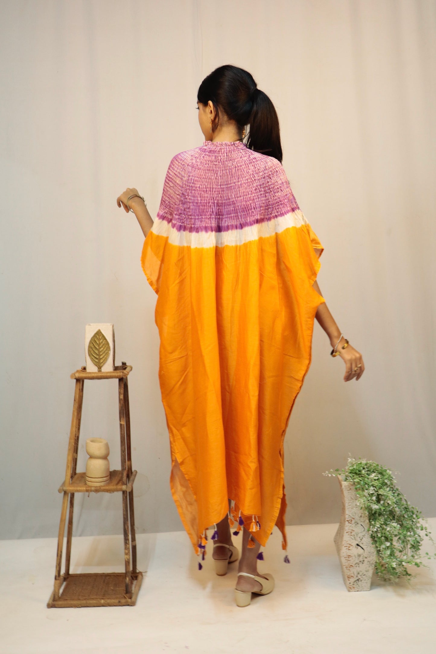 Handcrafted saffron fade silk kaftan featuring traditional Bandhani and Shibori textile artistry