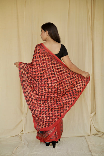 Premium scarlet and black modal silk saree with heritage-inspired Ajrakh designs and fluid texture