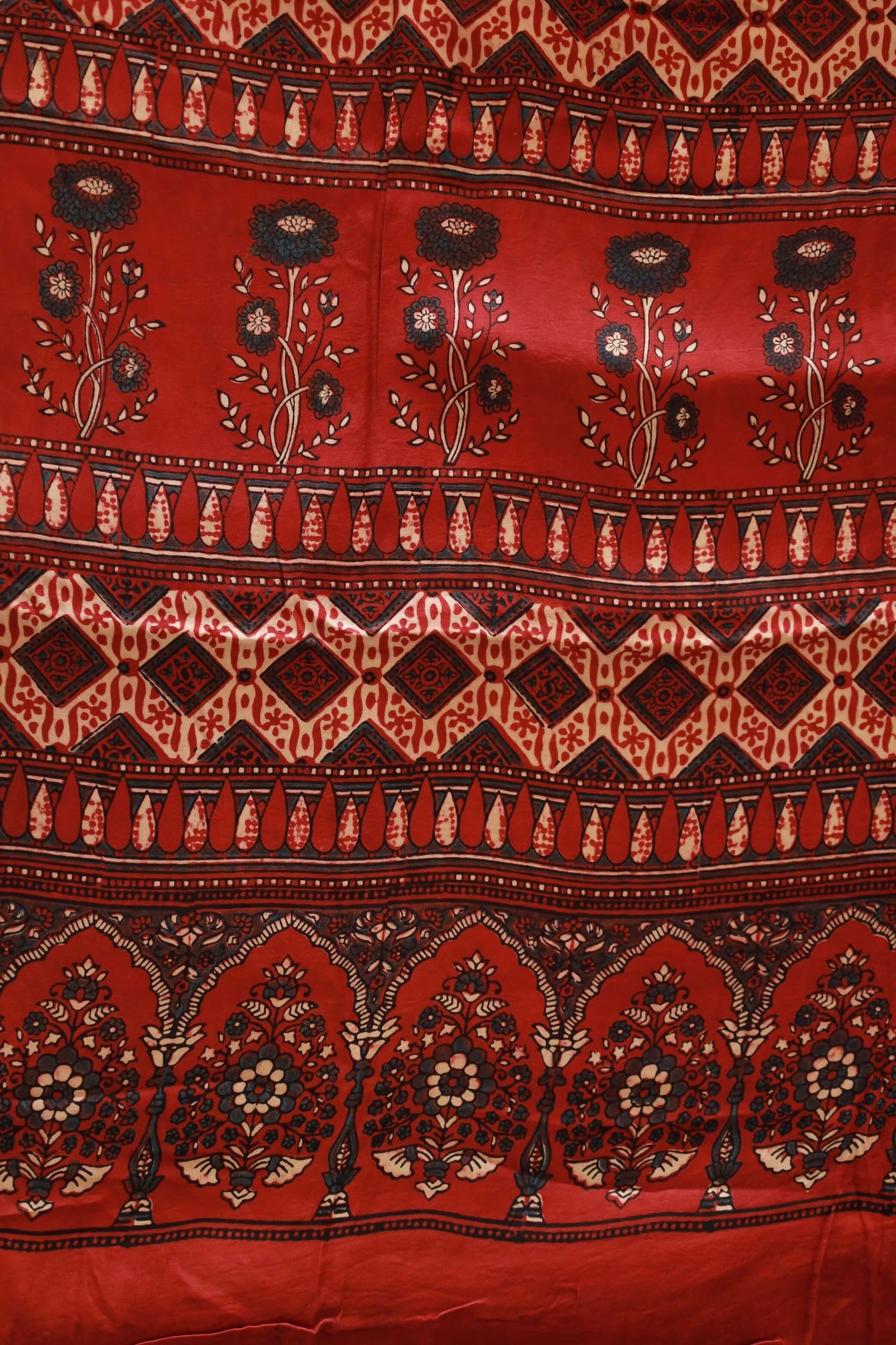 Handcrafted scarlet red modal silk saree with traditional Ajrakh patterns and soft luxurious texture