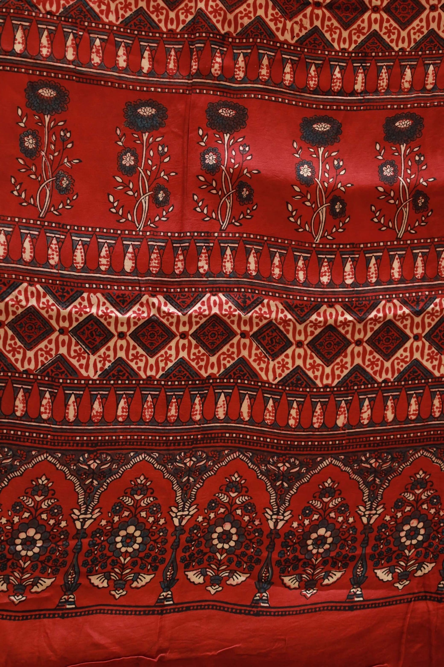 Handcrafted scarlet red modal silk saree with traditional Ajrakh patterns and soft luxurious texture