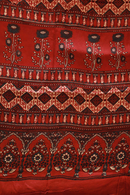 Handcrafted scarlet red modal silk saree with traditional Ajrakh patterns and soft luxurious texture