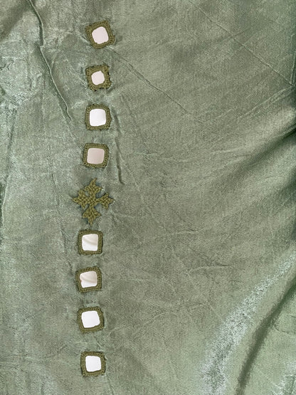 Soft green mirror work dress material showcasing intricate handcrafted embellishments