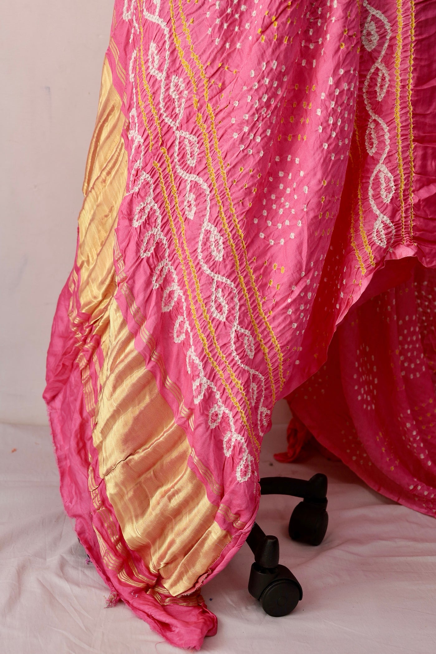 Soft pink Bandhani Gajji silk saree featuring intricate tie-dye patterns and an elegant zari pallu. Handcrafted soft pink Gajji silk saree showcasing authentic Bandhani artistry with rich zari detailing