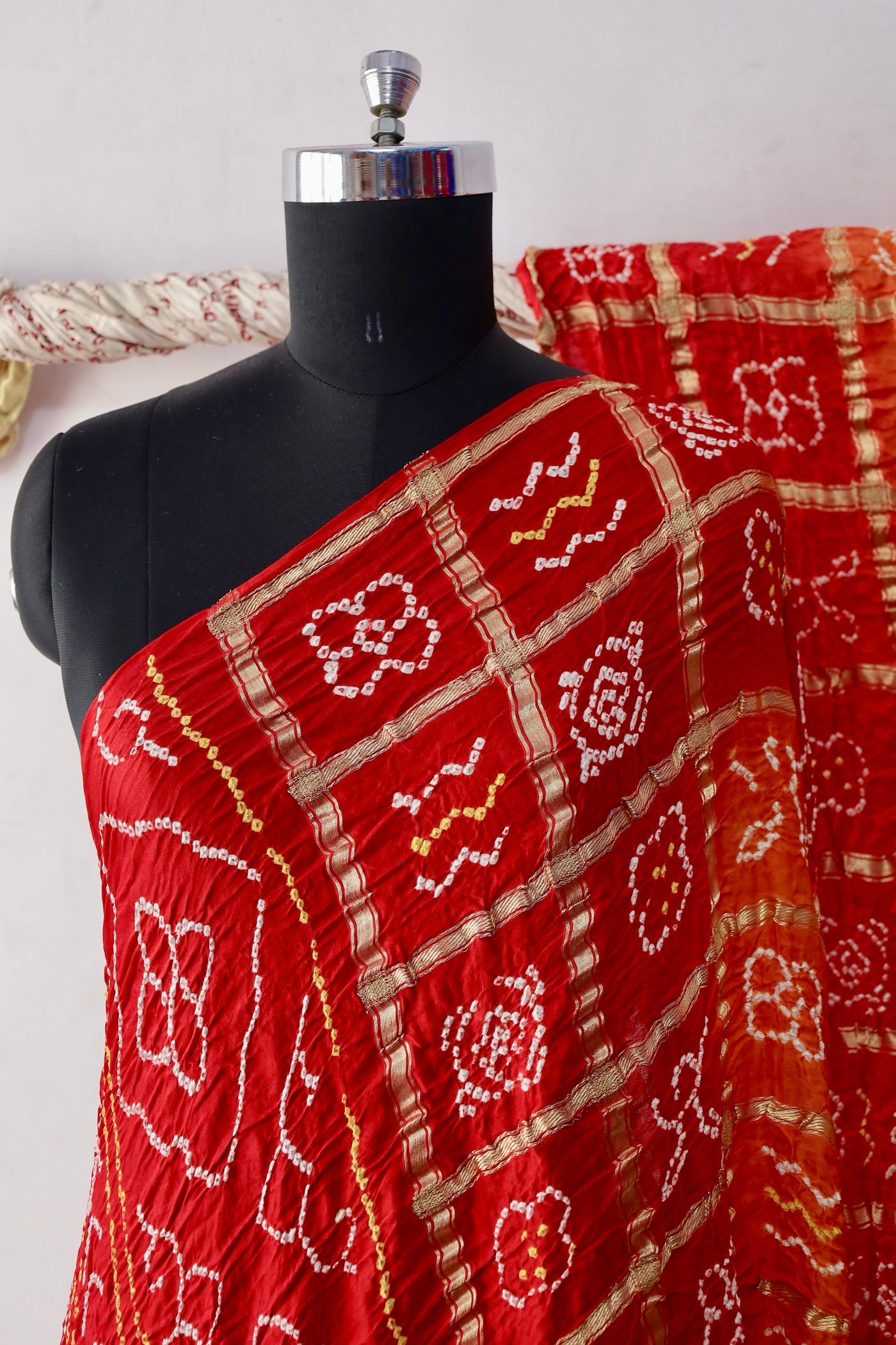 Traditional Bandhani Gharchola saree in sunset hues crafted from luxurious Gajji silk