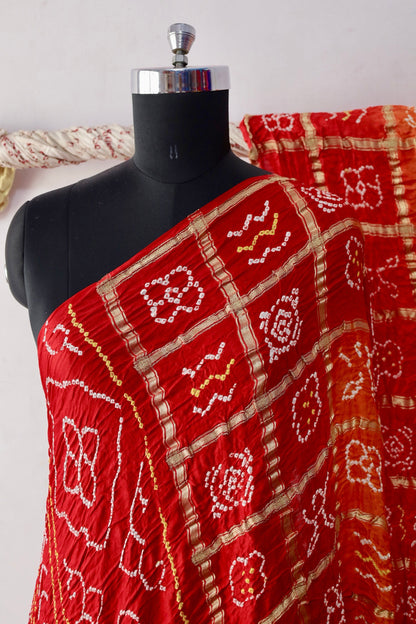 Traditional Bandhani Gharchola saree in sunset hues crafted from luxurious Gajji silk