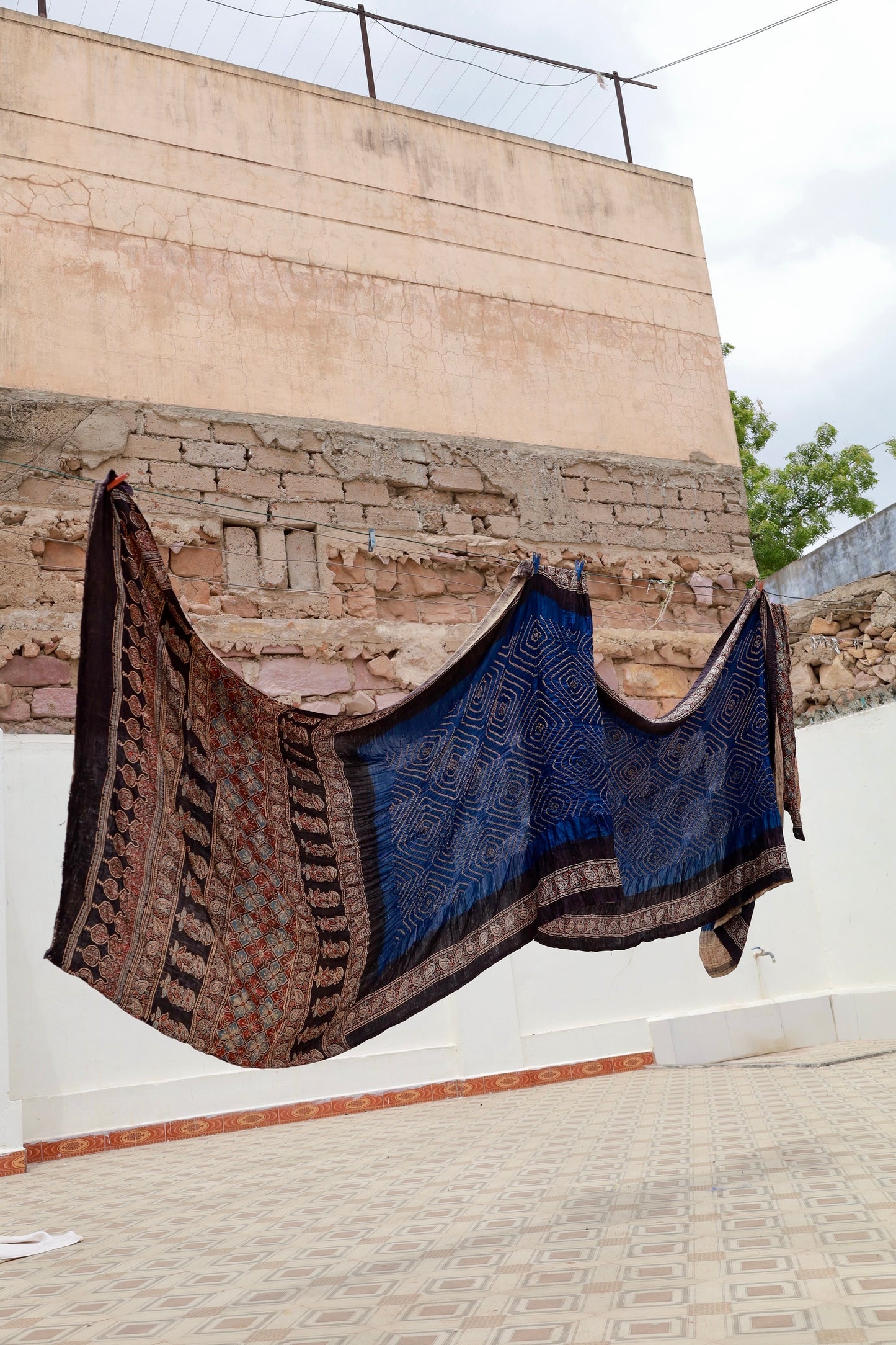 Handcrafted teal silk saree showcasing authentic Ajrakh and Bandhani artisan craftsmanship