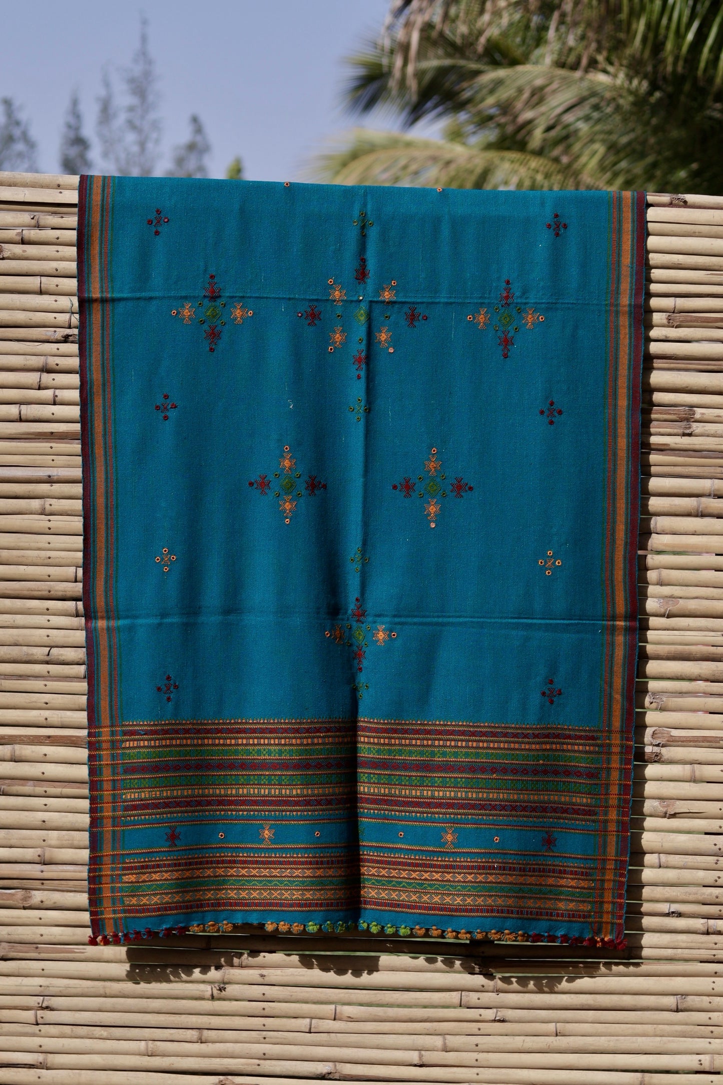 Elegant turquoise blue wool shawl handcrafted using traditional handloom weaving techniques