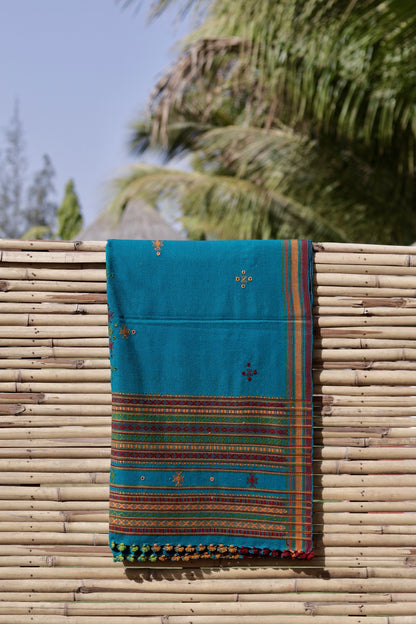 Turquoise blue handwoven woolen shawl featuring a refreshing hue and skilled artisan craftsmanship