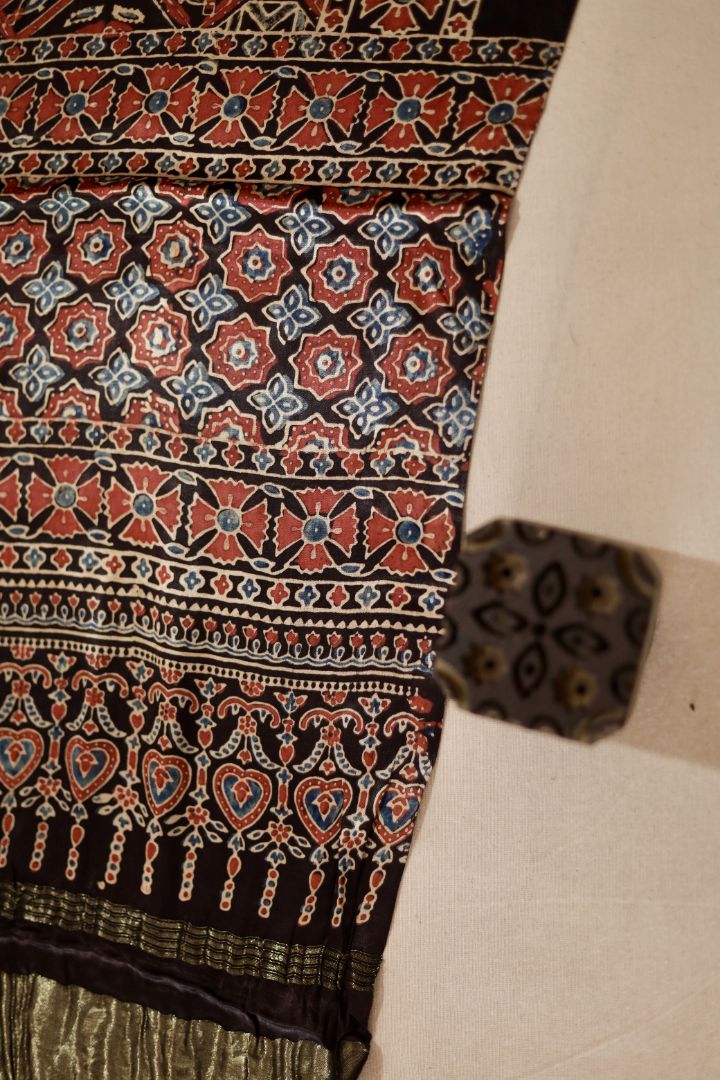 Traditional walnut brown Ajrakh modal silk dupatta showcasing authentic artisan craftsmanship and decorative borders