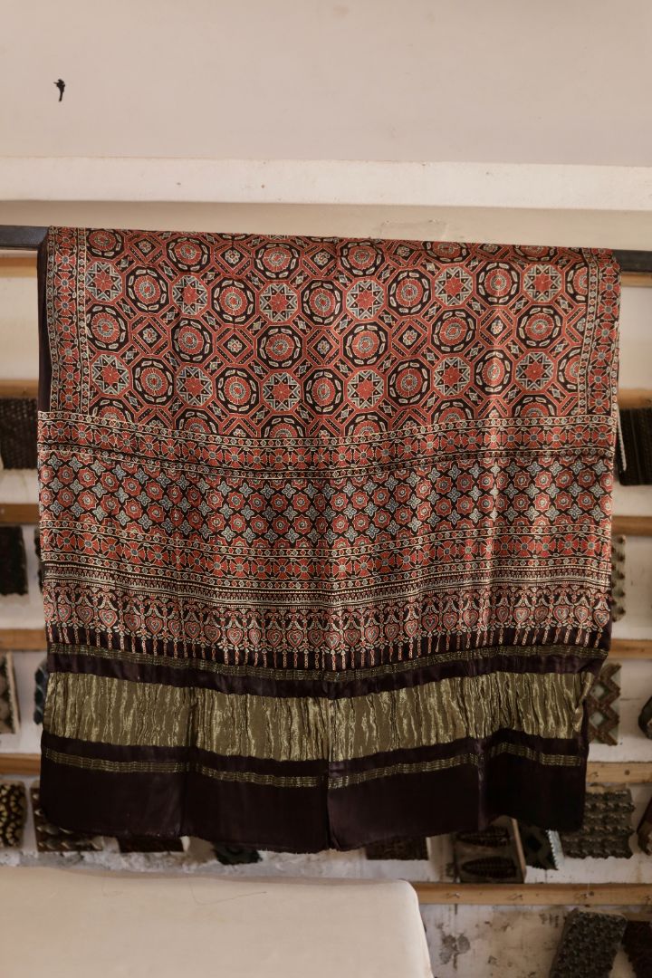 Walnut brown Ajrakh modal silk dupatta with Lagdi Patta featuring intricate block printed motifs and elegant drape