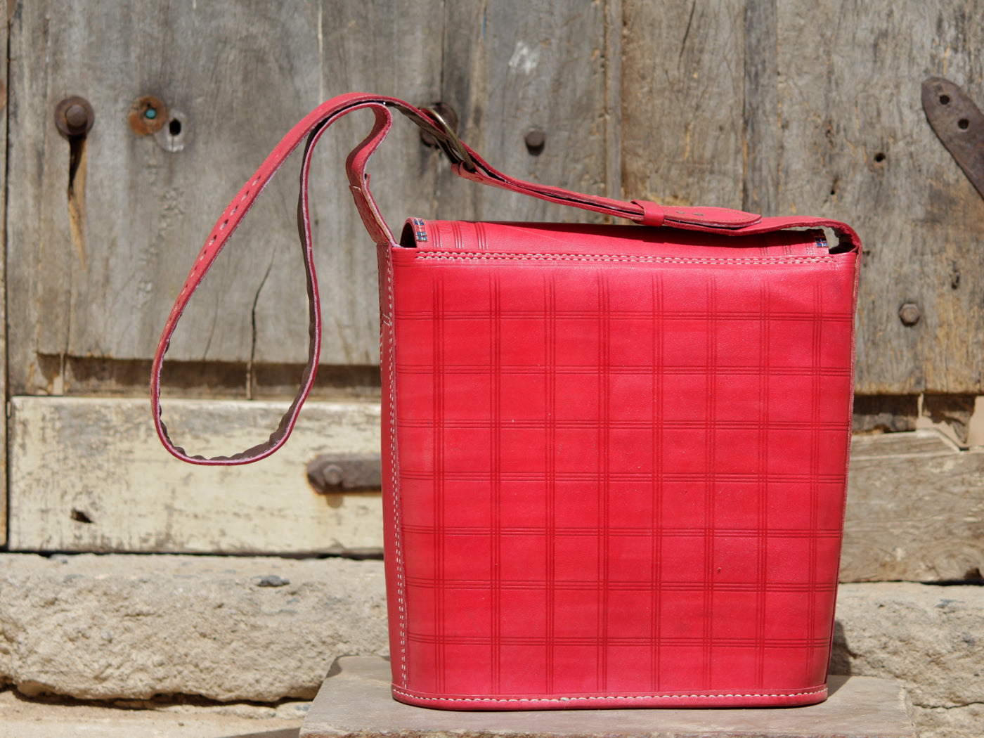 Artisan-made leather bag featuring traditional zari embroidery and fine detailing