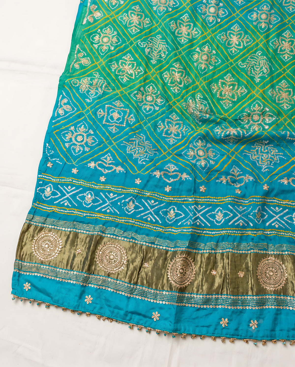 Folded aqua blue Bandhani dupatta showing patterns and gota patti work
