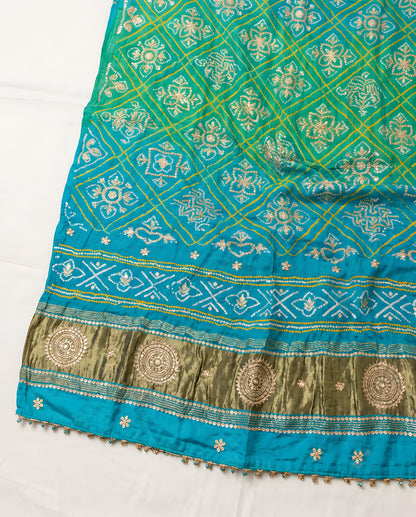 Folded aqua blue Bandhani dupatta showing patterns and gota patti work
