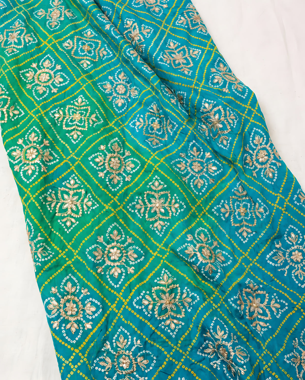 Close-up of gota patti detailing on aqua blue Bandhani dupatta