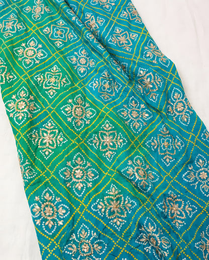 Close-up of gota patti detailing on aqua blue Bandhani dupatta