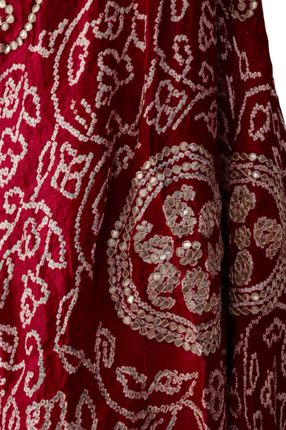 Red silk dupatta with curling Bandhani patterns and circular floral Gota Patti motifs
