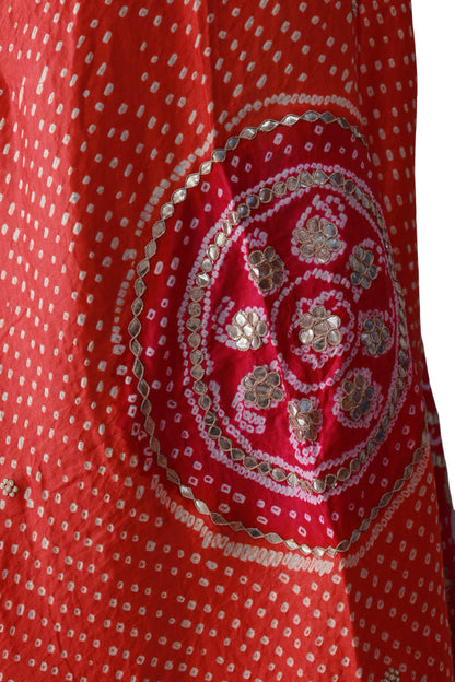 Orange silk dupatta with fine white Bandhani dots and a contrasting bright pink border