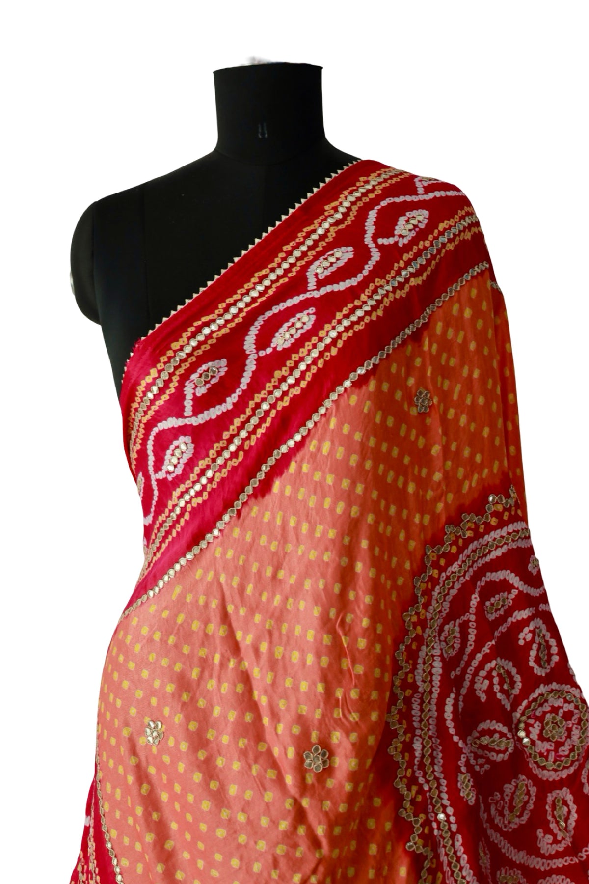 Red circular medallion with floral and leaf Gota Patti motifs on a peach Bandhani dupatta