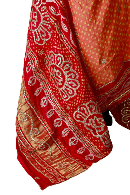 Peach silk dupatta with yellow Bandhani dots and scattered metallic floral embellishments