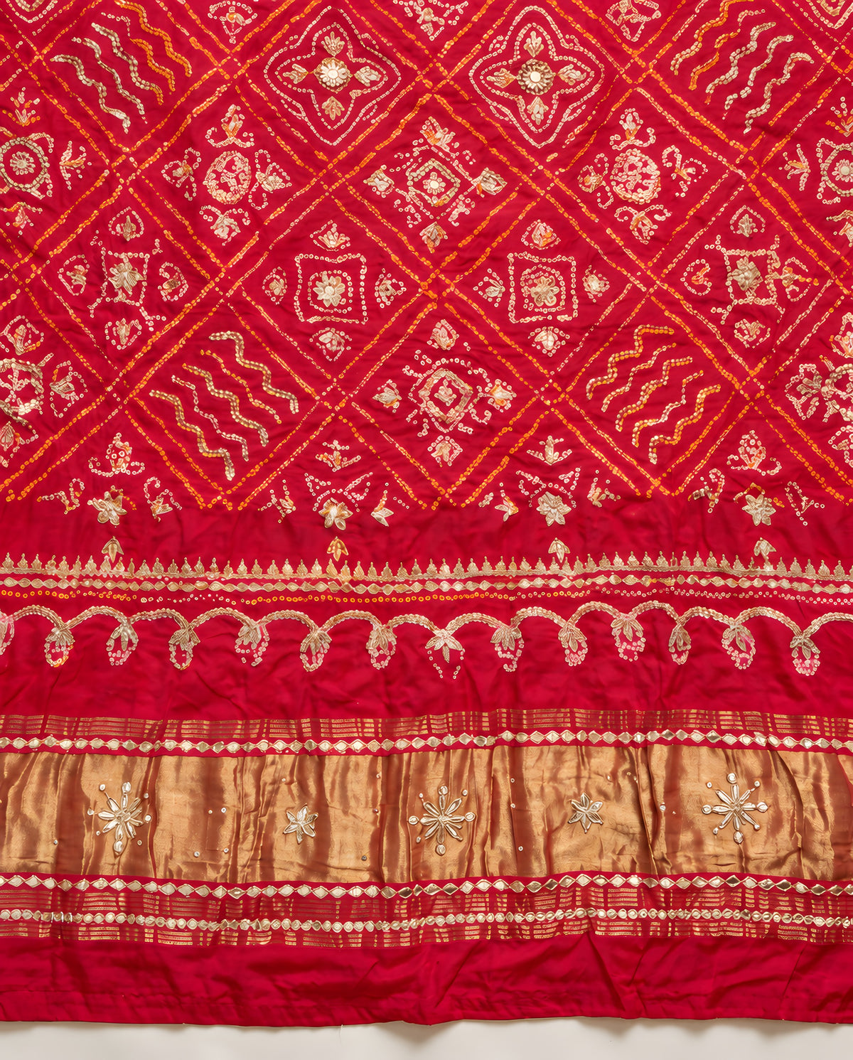 Border detailing on ruby red Bandhani gota patti dupatta