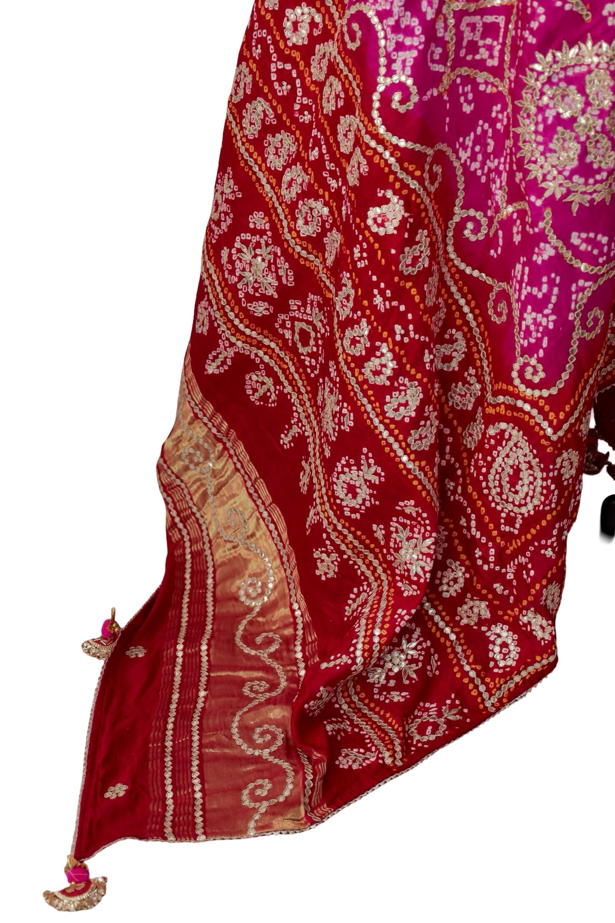 Circular floral Gota Patti medallions surrounded by curling Bandhani patterns on pink silk